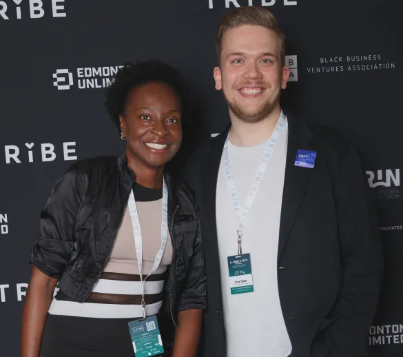 Two attendees at media wall